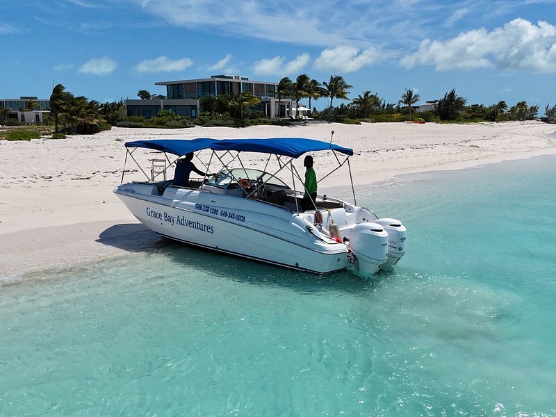 A small charter boat pulled up on a white-sand beach